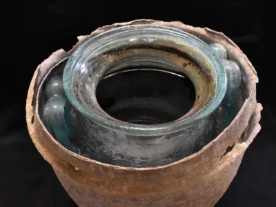 The wine, made of crushed white grapes 2,000 years ago, turned red-brown with age.